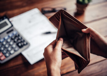 Someone opening an empty wallet, as a result of the Kansas cost problem.