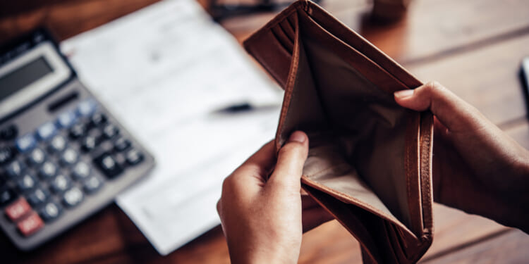 Someone opening an empty wallet, as a result of the Kansas cost problem.
