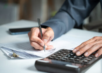 A taxpayer with a calculator trying to figure out his taxes.