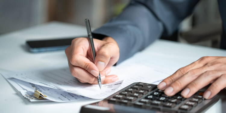A taxpayer with a calculator trying to figure out his taxes.