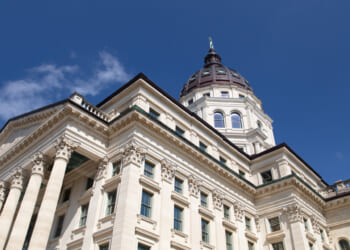 The Kansas state capitol against the blue sky. Kansas state lawmakers shouldn't depend on dollars from Washington.