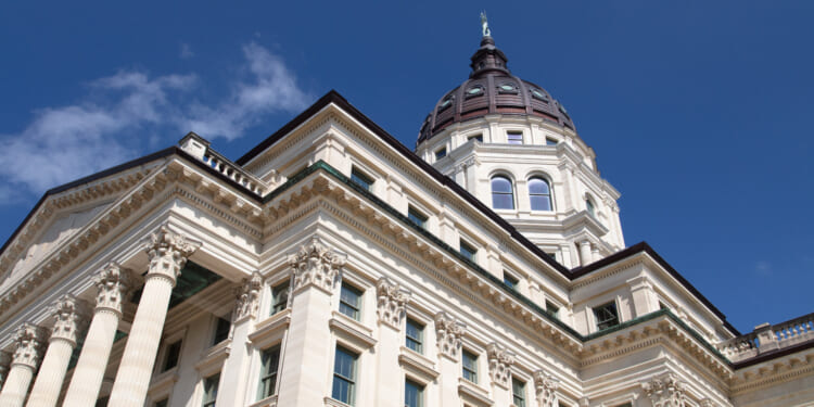 The Kansas state capitol against the blue sky. Kansas state lawmakers shouldn't depend on dollars from Washington.
